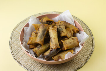 Pisang Aroma Cokelat or Banana chocolate spring roll, traditional Indonesian street food, made from banana fruit wrapped with spring roll stuff. Crispy texture and sweet taste. Isolated backround. 