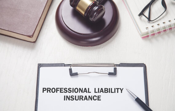 Text Professional Liability Insurance on clipboard.