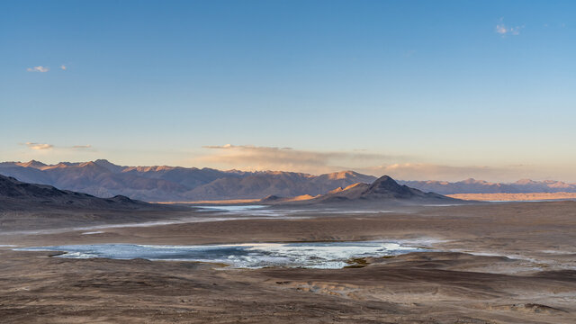 Panoramic sunset view of high-altitude Tuzkul salt lake with mountain background along Pamir Highway between Bulunkul and Alichur, Gorno-Badakhshan, Tajikistan