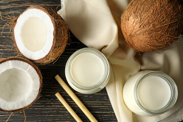 Fresh coconut and coconut milk on wooden background