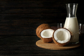 Fresh coconut and coconut milk on wooden background