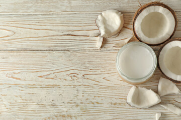 Fresh coconut and coconut milk on wooden background