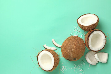 Fresh tasty coconut on mint background, top view
