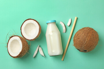 Fresh coconut and coconut milk on mint background