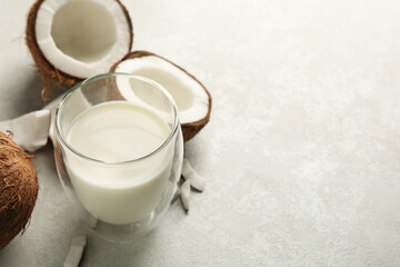 Fresh coconut and coconut milk on white background