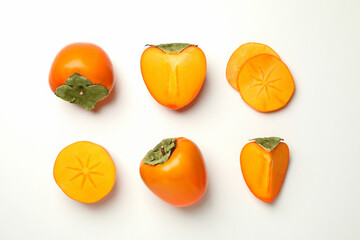 Flat lay with ripe persimmon on white background
