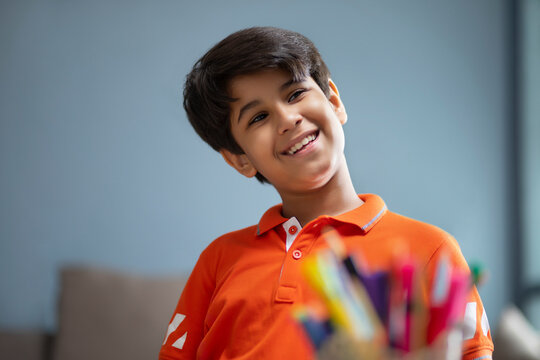 Young Boy Looking Sideways With A Smile On His Face	