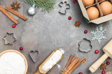 Fototapeta na wymiar Ingredients for cooking Christmas baking on dark rustic baking tray