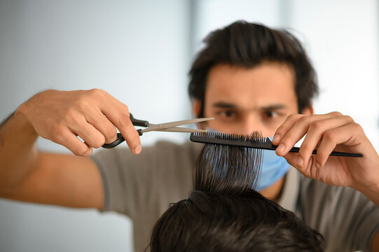 Close up of a barber doing haircut of a client	