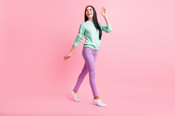 Fototapeta na wymiar Full length photo of friendly cute young woman dressed turquoise sweater waving arm isolated pink color background