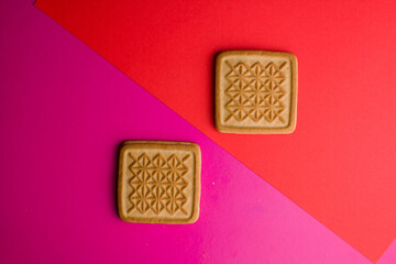 square cookies on a pink background on the table