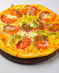 Pepperoni pizza on a white background. Traditional Italian pizza with tomatoes and meat isolated on white.