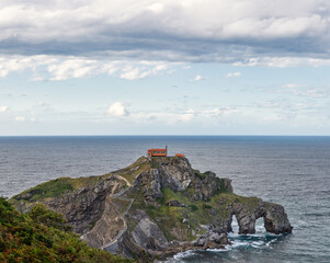 Fototapeta na wymiar beautiful dramatic and cloudy landscape of a hermitage on a rock mountain within the sea