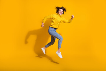 Full length body size side profile photo of jumping high hurrying up female hipster isolated on vivid yellow color background