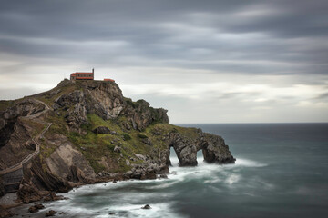 Fototapeta na wymiar beautiful dramatic and cloudy landscape of a hermitage on a rock mountain within the sea