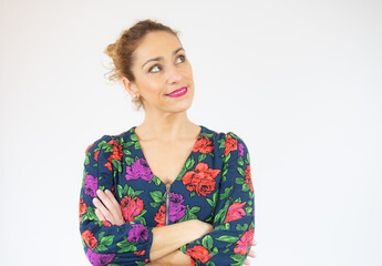 Portrait of a smiling young woman standing with arms folded isolated over white background