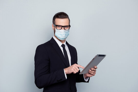 Photo of handsome smart intelligent expert wear suit fsce mask holding digital gadget isolated gray color background