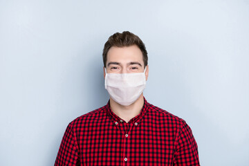 Portrait of young person look camera wearing safe medical flu cold mask isolated on grey color background