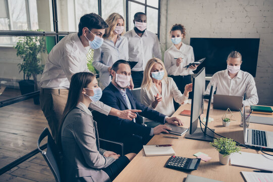 Portrait of business colleagues communicate make new plans look screen wear safety facial mask office indoors