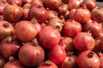 many large red pomegranate in fruit market