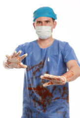 Vertical shot of a bloody surgeon protecting himself after a failed operation