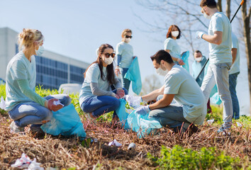 volunteering, health and ecology concept - group of volunteers wearing face protective medical...