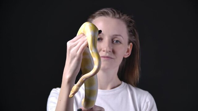 Slow motion footage of girl holding albino python