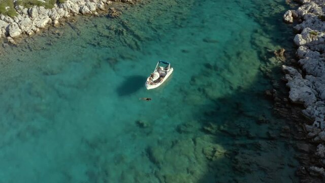 Tourists on Greece Vacation Swimming by Boat in Ionian Sea Island of Paxos