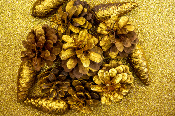  Christmas decorations with Pine Cone fortuna gold color as texture background. Hight quality photo