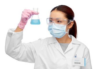 science, chemistry and people concept - young asian female scientist in mask and goggles with chemical in flask making test or research