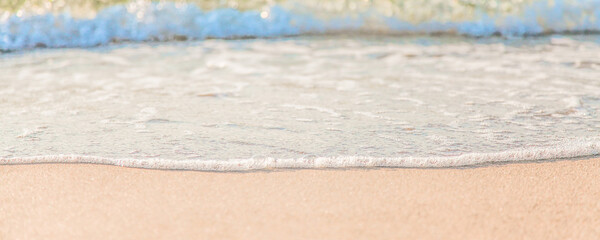 the waves of the sea on the sandy beach on a sunny day