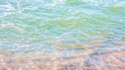 crystal clear azure water with sea foam, seascape background