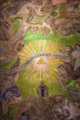 Ceiling of the cathedral with ancient paintings and the name of God, Jehovah (tetrogramaton, YHWH) in the very center. Saints Peter and Paul Garrison Church (Jesuit Church), 17th century, Lviv, Ukrain