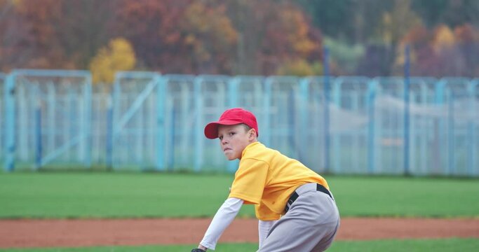Baseball at school, the pitcher pitches fastball toward batter, young boy throwing the ball, 4k slow motion.