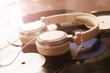Headphones lying on a vinyl records. Music concept.