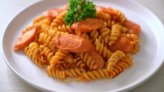 spiral or spirali pasta with tomato sauce and sausage - Italian food style