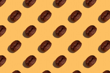 Seamless regular pattern with coffee beans on a yellow background. Hard light.