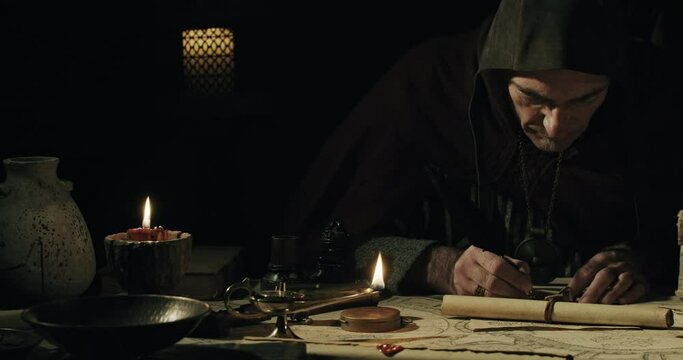 Ancient scribe writing with quill pen on old parchment