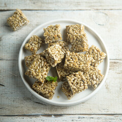 Healthy seeds honey squares on a wooden desk