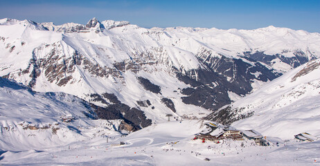 Winter landscape in the Alps. chalet house in Mayrhofen sports region in the Zillertal. Ski slopes in the background of mountains