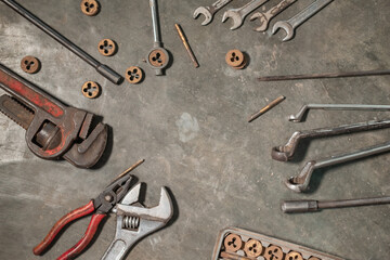 image of several workshop tools on the floor, wrenches, wrenches, pipe wrenches, pliers and bolts