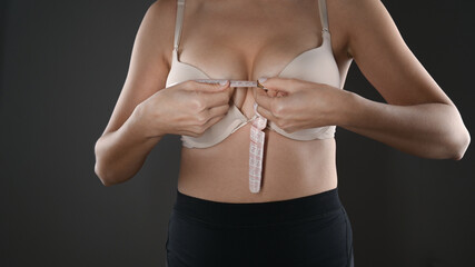 The girl makes a measurement of her chest