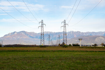 poles of power lines in the field