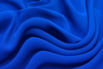 Abstract blue color silk chiffon fabric texture. A mockup of silk tissue as background at  the...
