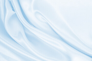 Smooth elegant blue silk or satin luxury cloth texture as abstract background. Luxurious background design
