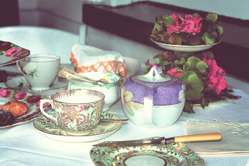 Retro photo of table set for tea. Toned image.