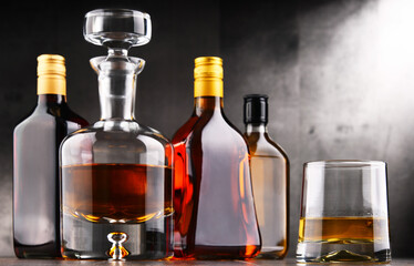 Carafe and bottles of assorted alcoholic beverages.