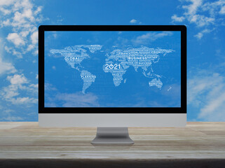 Start up business flat icon with global words world map on desktop modern computer monitor screen on wooden table over blue sky with white clouds, Happy new year 2021 global business start up concept,