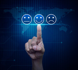 Hand pressing excellent smiley face rating icon over digital world map technology style, Business customer service evaluation and feedback rating concept, Elements of this image furnished by NASA