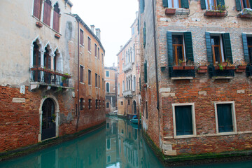 Fototapeta na wymiar Picturesque view of ancient buildings and channel with gondolas in Venice, Italy. Beautiful romantic italian city. Unique Venetian landscape.